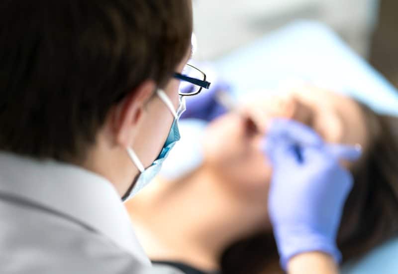 Doctor removing a wisdom tooth