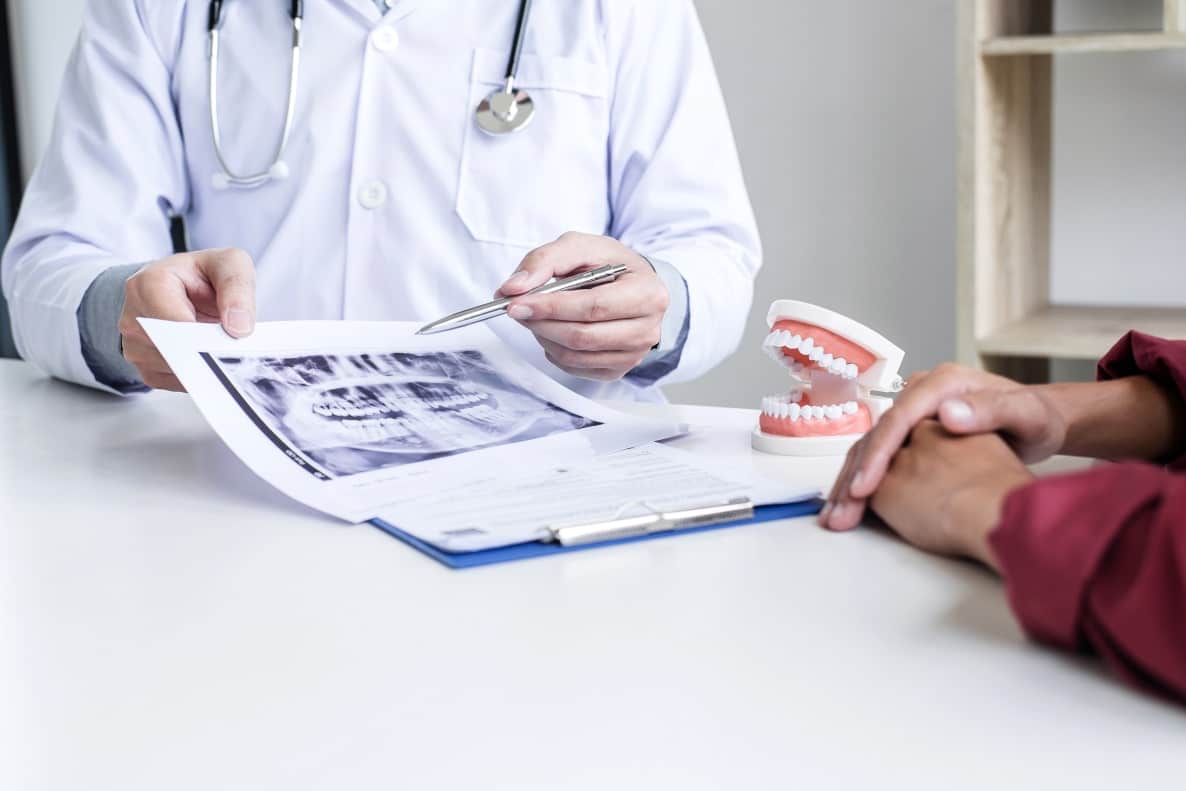 Oral surgeon discussing treatment options with patient