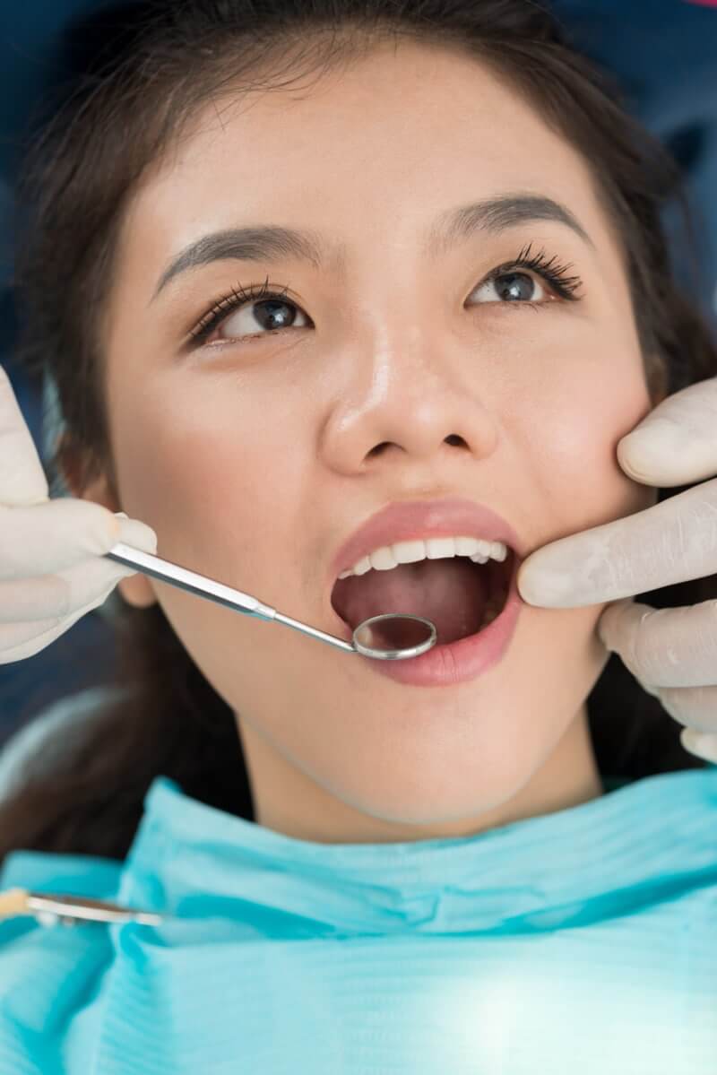 A doctor is giving oral pathology service to a patient in Austin and Marble Falls, TX.